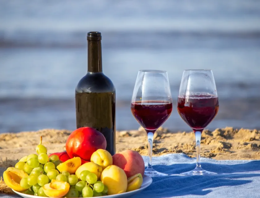 Picnic wine for summer season, wine, fruit, beautiful sea beach. Selective focus